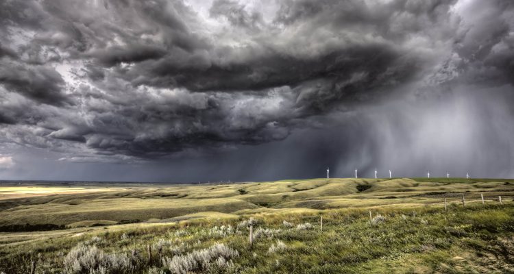 Storm clouds forming over a wind farm