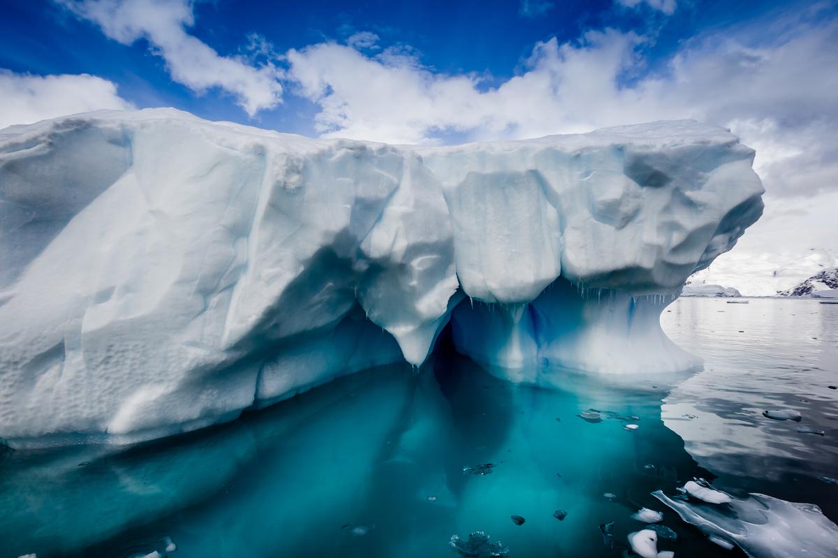 Antarctic ice shelf splitting off to form massive iceberg