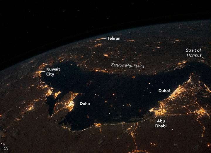 City lights surround the Persian Gulf
