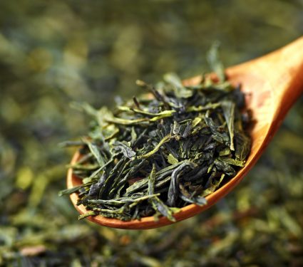 Traditional,Organic,Chinese,Dry,Green,Tea,Leaves,On,Wooden,Spoon