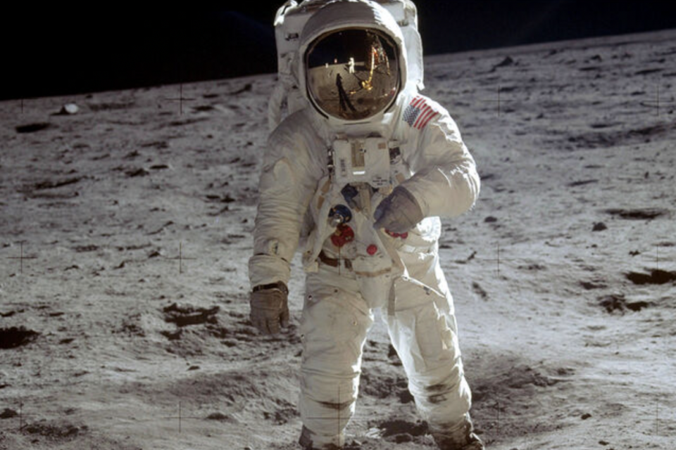 Buzz Aldrin traversing across the surface of the moon