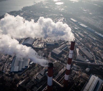 Air,Pollution,By,Smoke,Coming,Out,Of,Two,Factory,Chimneys.