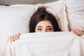 Model,Woman,Hiding,Under,The,Blanket.,Young,Woman,Is,Very