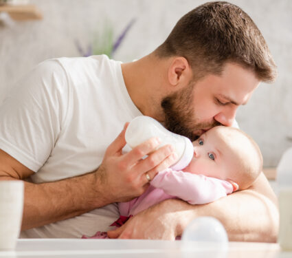 Young,Father,Kiss,His,Baby,During,Drinking,Milk