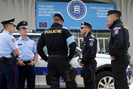 Members of the European Border and Coast Guard Agency known as FRONTEX and Albanian police officers stand in front of their vehicles before starting a mission on Albania-Greece border, in Tirana
