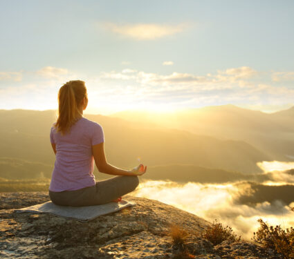 Woman,Meditating,Practicing,Yoga,Exercise,In,The,Mountain,At,Sunset
