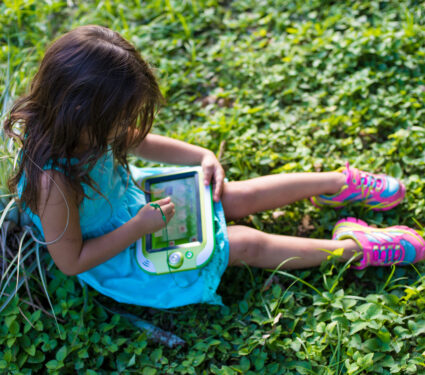 Beautiful,Girl,With,Electronic,=,Device,In,The,Park