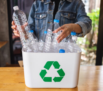 A,Woman,Collecting,And,Separating,Recyclable,Garbage,Plastic,Bottles,Into