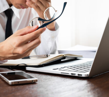 Tired,Man,Using,Laptop,At,The,Office,Or,Home