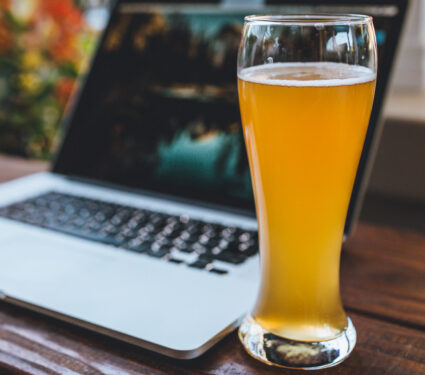 Computer,And,Beer,On,A,Wooden,Desk,Or,Table.,Modern