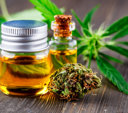 Green,Leaves,Of,Medicinal,Cannabis,With,Extract,Oil.medical,Marijuana,Flower