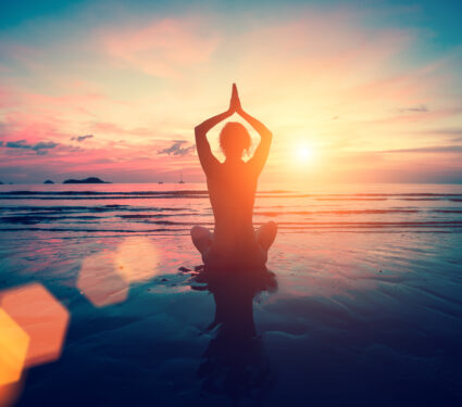 Silhouette,Young,Woman,Practicing,Yoga,On,The,Beach,At,Sunset.