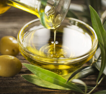 Bottle,Pouring,Virgin,Olive,Oil,In,A,Bowl,Close,Up