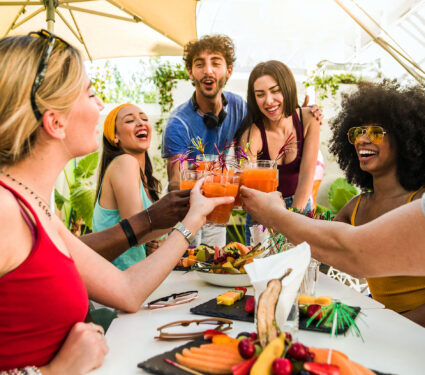 Group,Of,Happy,Multiracial,Friends,Having,Fun,Drinking,And,Toasting