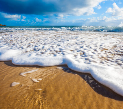Waves,Wash,Over,Golden,Sand,On,Australian,Beach