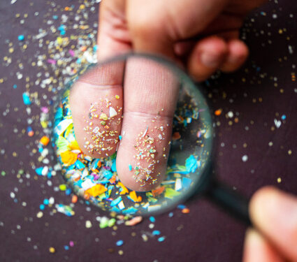 Close-up,Of,Micro,Plastic,Particles,On,The,Fingers,Under,A