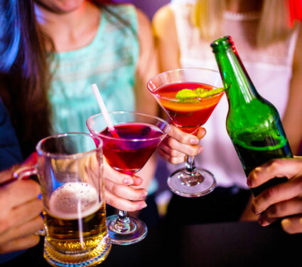 Group,Of,Friends,Toasting,Cocktail,,Beer,Bottle,And,Beer,Glass