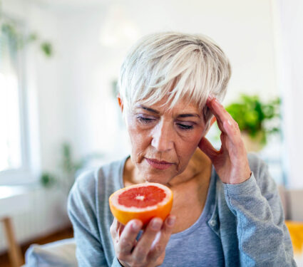 Sick,Woman,Trying,To,Sense,Smell,Of,Half,Fresh,Orange,