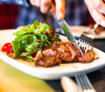 Man,Eating,Meat,With,Salad