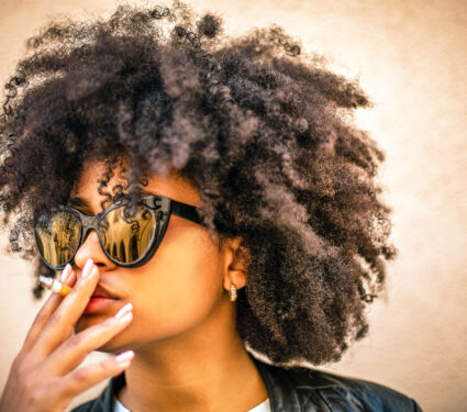 African-american,Girl,With,Sunglasses,Smokes,A,Cigarette.,She,Smokes,With