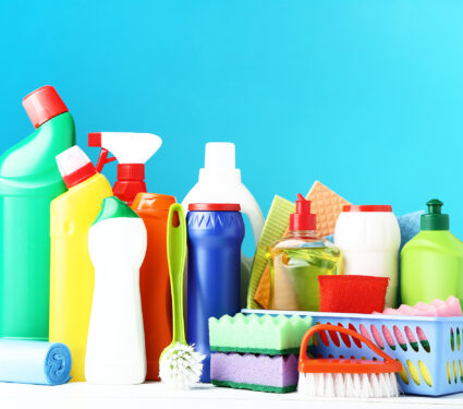 Bottles,With,Detergent,And,Cleaning,Tools,On,Wooden,Table