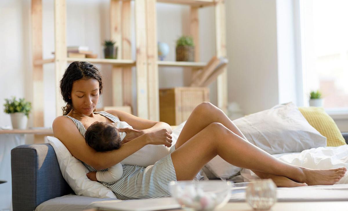 What triggers the release of breast milk in mothers?