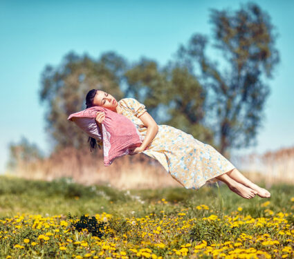 Girl,Hovers,And,Sleeps,On,A,Pillow,Over,A,Beautiful