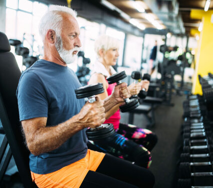 Happy,Fit,Mature,Man,In,Gym,Working,Out,To,Stay