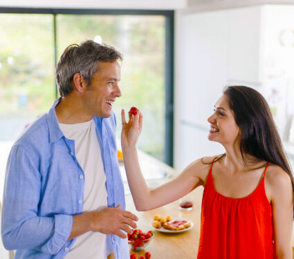 Young,Woman,Give,A,Strawberry,To,Her,Man,In,The