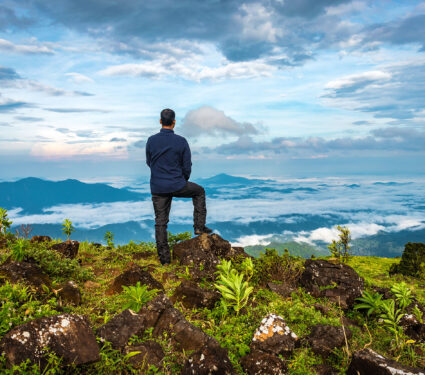 Man,Isolated,Watching,The,Serene,Nature,At,Hill,Top,With