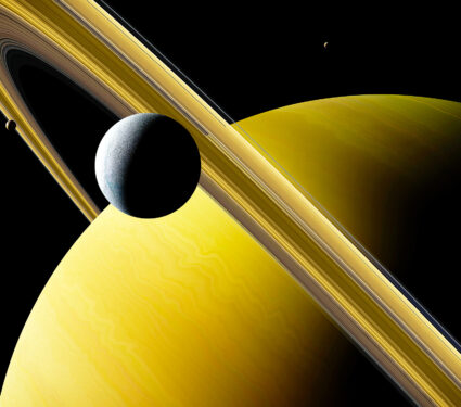 Saturn's,Moon,Enceladus,In,Front,Of,Planet,Saturn,,Rings,And