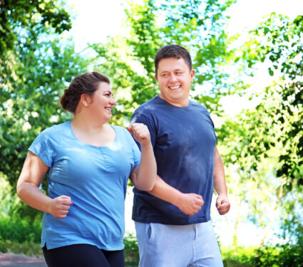 Overweight,Couple,Running,In,Green,Park