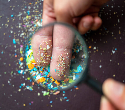 Close-up,Of,Micro,Plastic,Particles,On,The,Fingers,Under,A