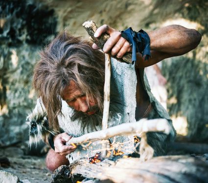 Close-up,Shot,Of,A,Primeval,Caveman,Wearing,Animal,Skin,Trying