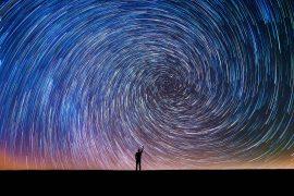 Man,Pointing,North,In,A,Spiral,Star,Trail