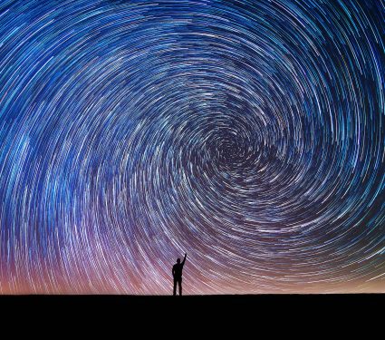 Man,Pointing,North,In,A,Spiral,Star,Trail