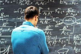 Brilliant,Young,Mathematician,Approaches,Big,Blackboard,And,Thinking,About,Sophisticated
