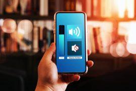 Close-up,View,Of,Hand,Turning,Down,The,Volume,Of,Smartphone