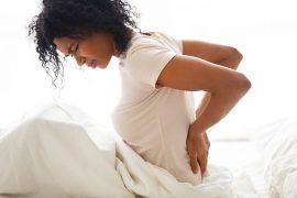 Sad,Young,African,Woman,Touching,Back,Feeling,Backache,Morning,Discomfort
