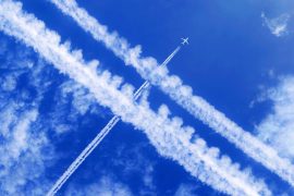 A,Passenger,Aircraft,With,Contrails,In,The,Blue,Sky,Crosses