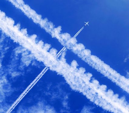 A,Passenger,Aircraft,With,Contrails,In,The,Blue,Sky,Crosses