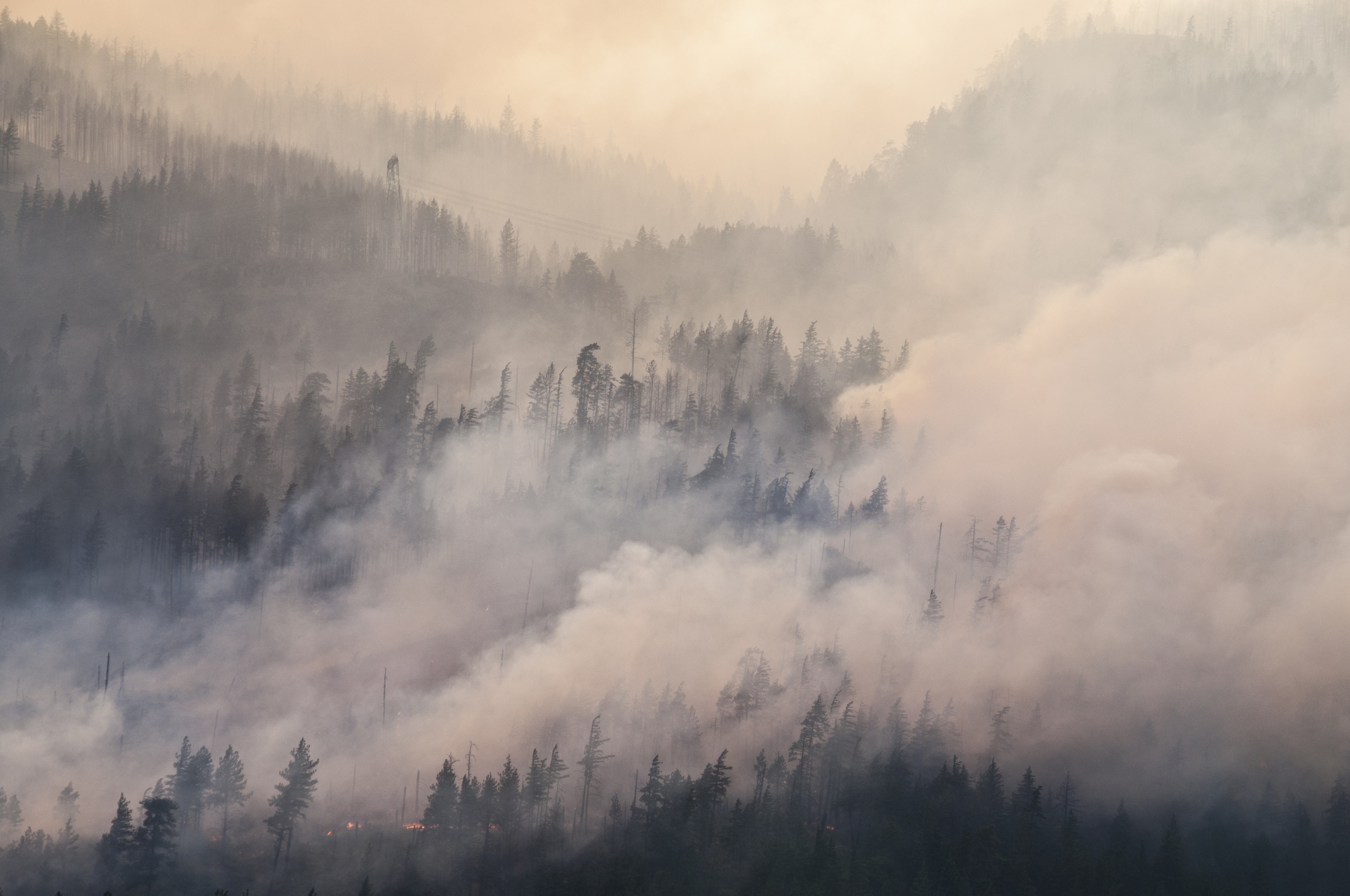 How does smoke from wildfires affect the atmosphere?