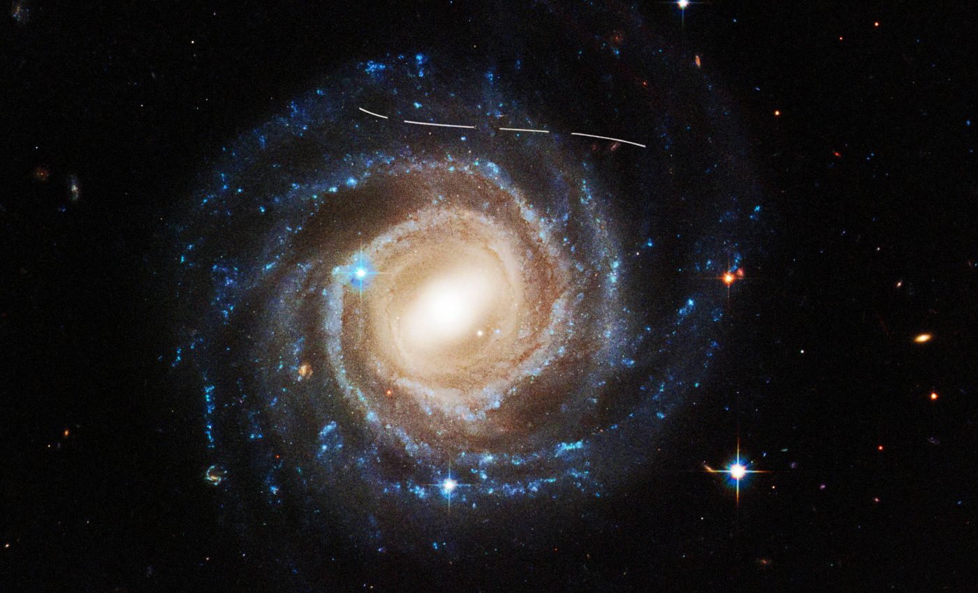 Hubble gets photobombed by an asteroid in beautiful image of a spiral galaxy
