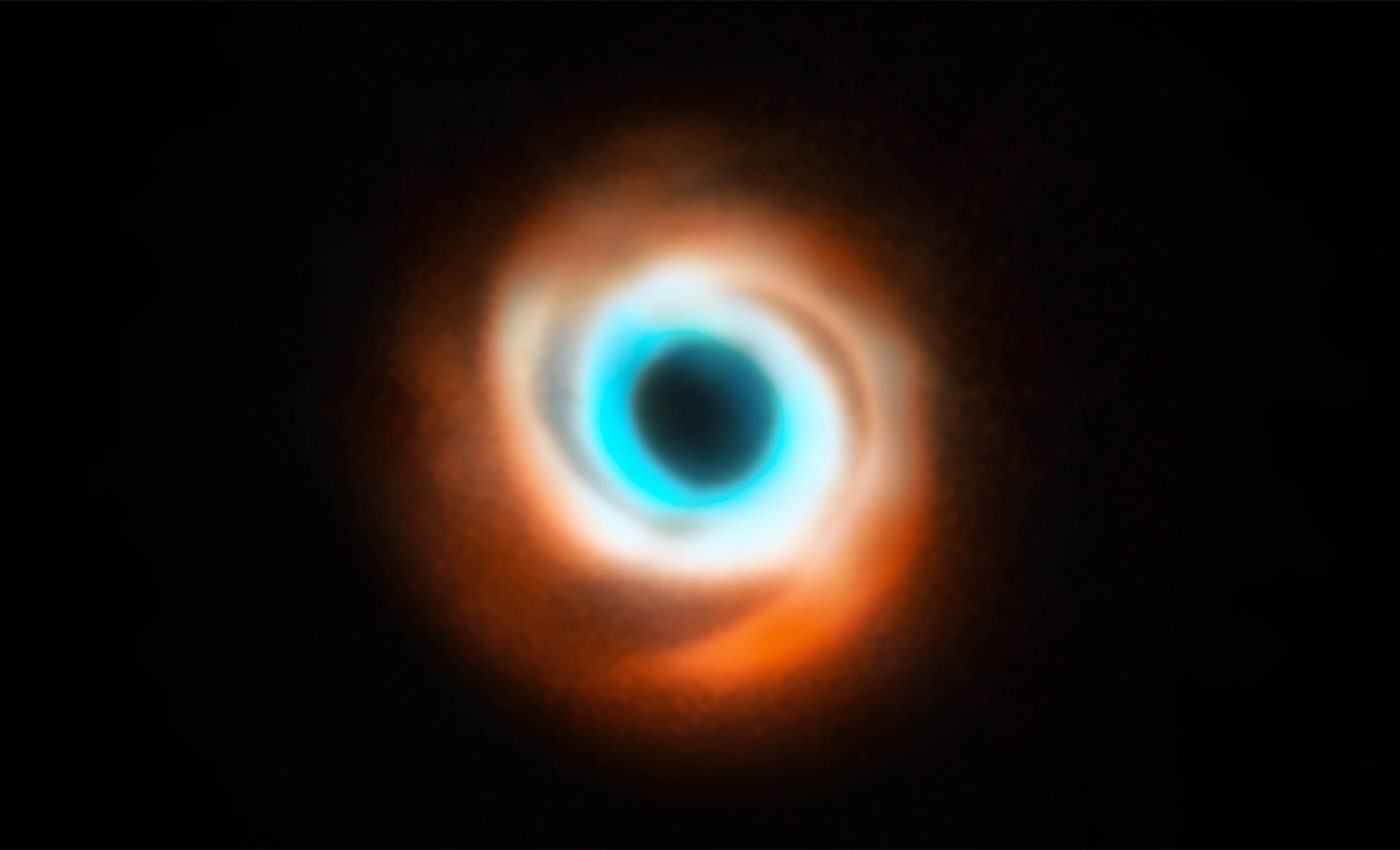 Astronomers capture video of a newborn planet sculpting its dust disk for the first time ever