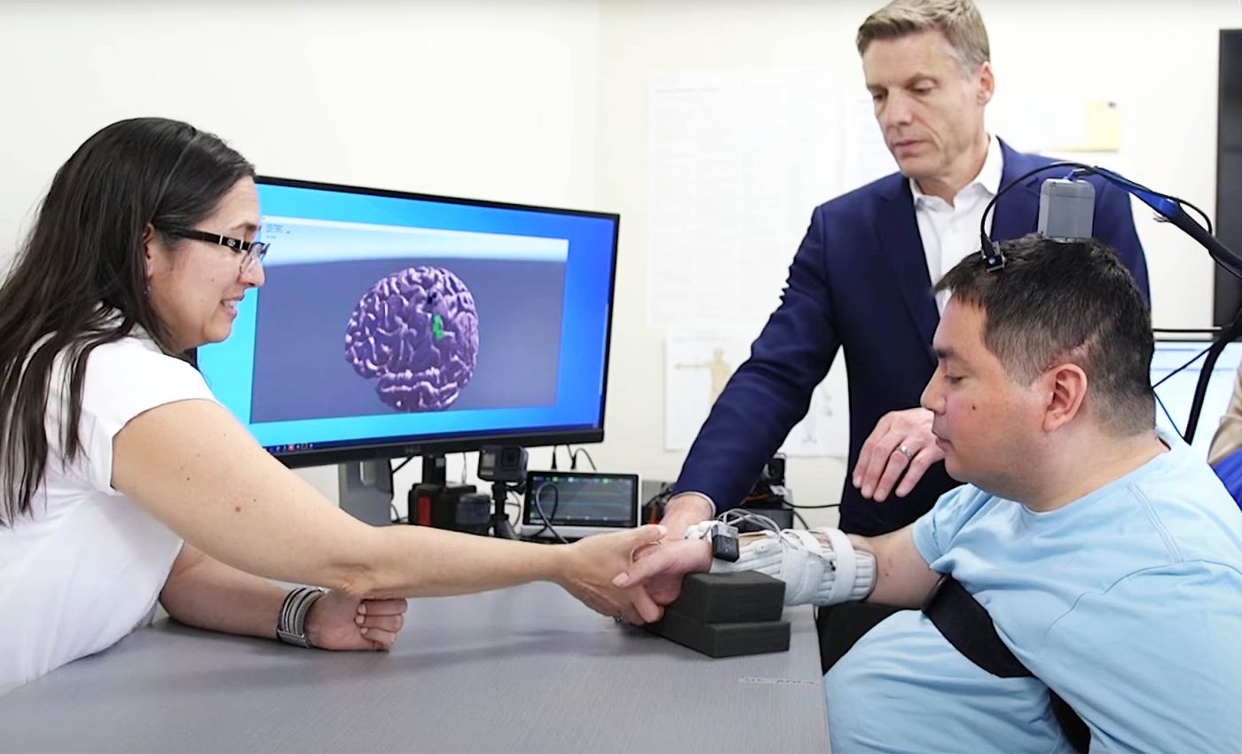 Implant allows a paralyzed man to control an object using another person's hand